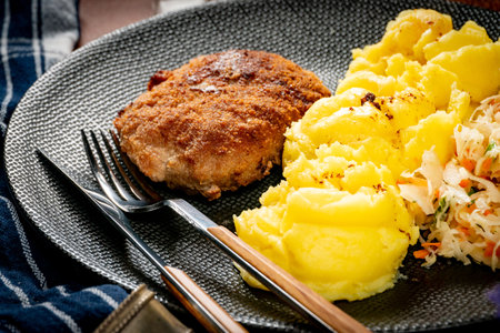 Homemade minced meat cutlet served with mashed potatoes and salad.の写真素材