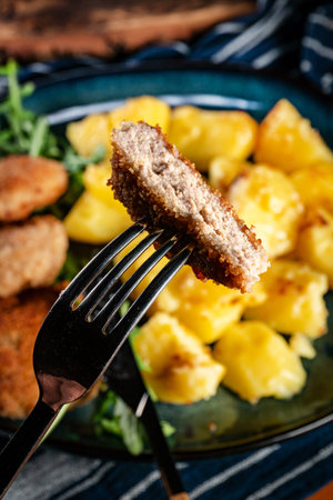 Meatballs served with boiled potatoes on a plate.の写真素材