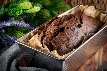 Freshly baked chocolate cake in a rectangular baking tin.