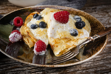 Homemade pancakes with white cheese and fruit.の写真素材