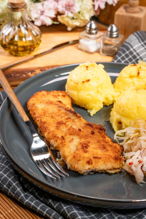 Fried pollock fillet served with boiled potatoes.の写真素材
