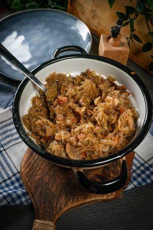 Stewed cabbage with pork, sausages and mushrooms. Bigos - traditional Polish cuisine.の写真素材
