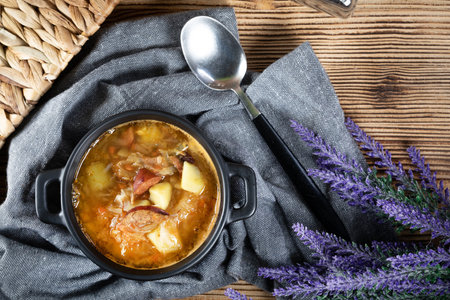 Traditional sour cabbage soup on wooden table. Selective focus.の写真素材
