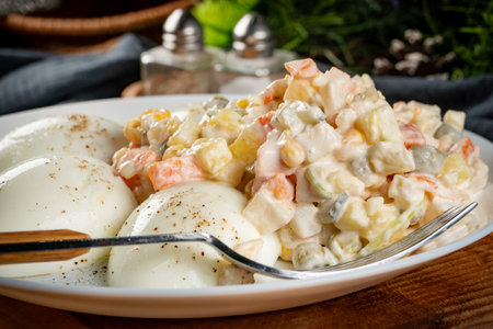 Boiled eggs with vegetable salad with mayonnaise.