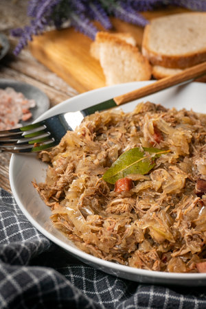 Bigos - sauerkraut stewed with meat, dried mushrooms and sausage. Traditional dish of Polish...
