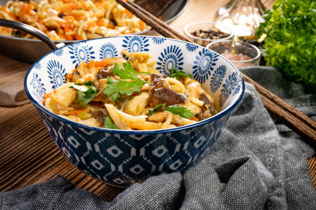 Fried noodles with chicken and vegetables. Chicken chow mein.