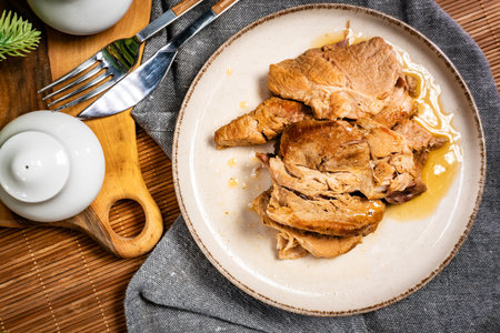 Plate with delicious cooked pork. Shallow depth of field.の写真素材