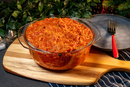 A stew of onions, vegetables and tomatoes in a bowl.