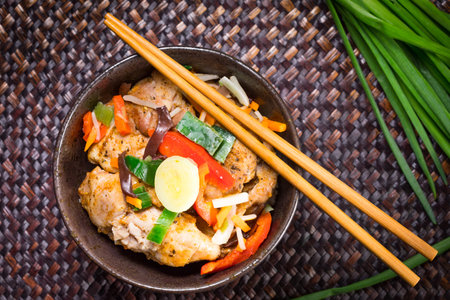 Fried pieces of chicken served with rice and vegetables. Top view.