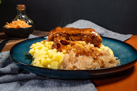 Braised pork ribs with spicy sauce served with mashed potatoes and sauerkraut. Shallow depth of...