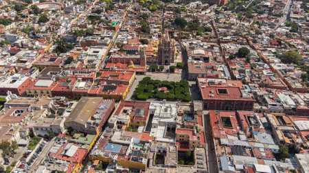 the church Parroquia Archangel Jardin Town Square Night Tree Decoraciones San Miguel de Allende, MÃ©xico. Parroaquia. Night and morning light in a drone view.の写真素材