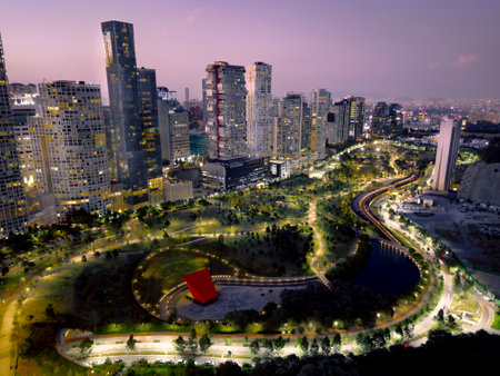 Drone photo of La Mexicana Park in Santa Fe, Mexico City, during blue hour. Green areas blend with...