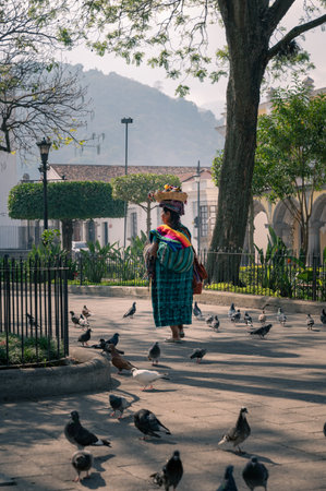 Indigenous Guatemalan woman selling crafts in Antigua with traditional dressの写真素材