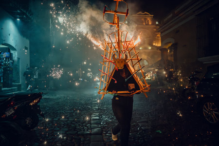Night shot of girl running with firework bull in Antigua Guatemalaの写真素材