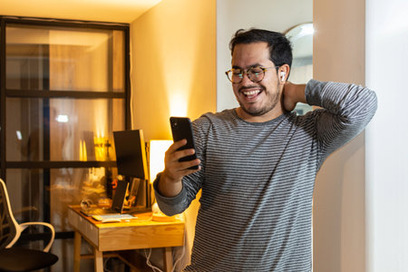 Worried Entrepreneur Reading Bad News on Phone at Home Officeの写真素材