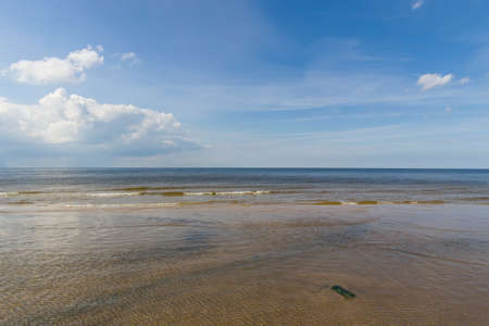 Landscape background with light clouds over Baltic sea near shoreline, selective focus.の写真素材