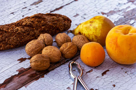 still life with Snack with bread with cereals, walnuts, pear, peach and apricot