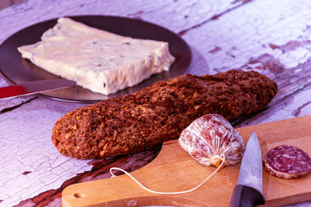 closeup of salami sausages on wooden board