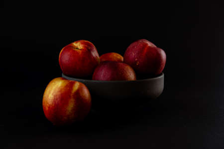 closeup view of delicious red peaches on black backgroundの写真素材