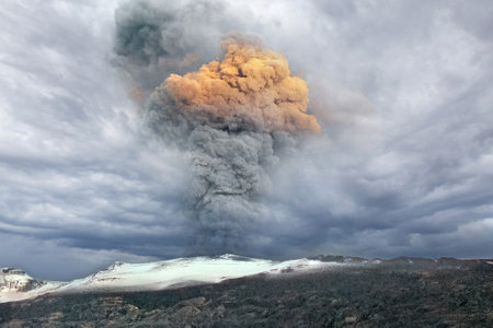 The Eyjafjallajokull volcano erupts with red smoke under a very dark, cloudy sky. Iceland