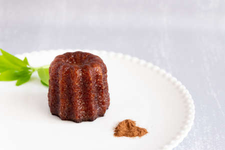 Canele, French confectionery, on a white and grey backgroundの写真素材