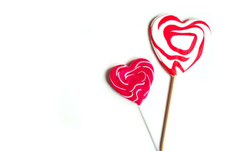 Top view of two heart-shaped lollypops on white background, Valentine's Day concept, copy spaceの写真素材