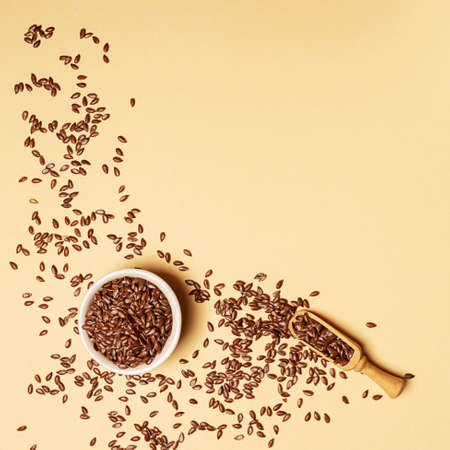 Flax seeds in a jar on yellow background with copy spaceの写真素材
