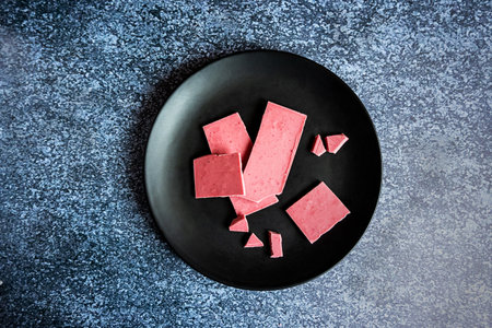 Pink or ruby chocolate, trendy dessert on a black plateの写真素材