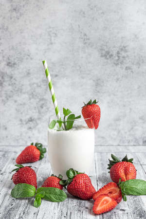 A glass of milk shake and fresh strawberriesの写真素材