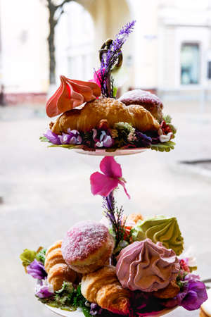Composition of marshmallows and croissants on a stand