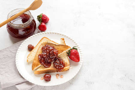 Toasted bread slices with strawberry jamの写真素材