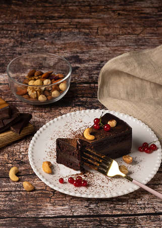 Raw vegan chocolate cake on dark vintage backgroundの写真素材