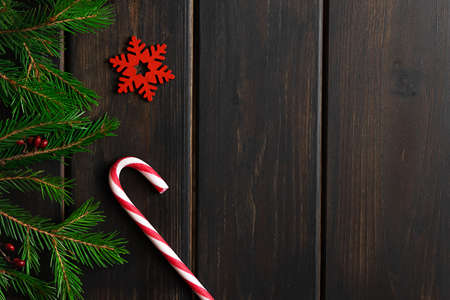 Dark wooden background with Christmas decorations and fir treeの写真素材