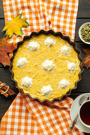 Top view of a homemade pumpkin pie on dark wooden backgroundの写真素材