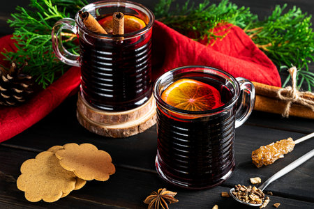 Two cups of hot mulled wine on a dark wooden backgroundの写真素材