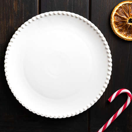 White plate on dark wooden background, copy spaceの写真素材