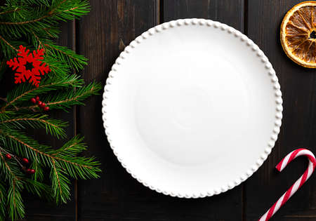 White plate on dark wooden background, copy spaceの写真素材