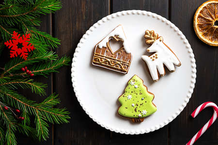 Christmas cookies on a plate on dark wooden backgroundの写真素材