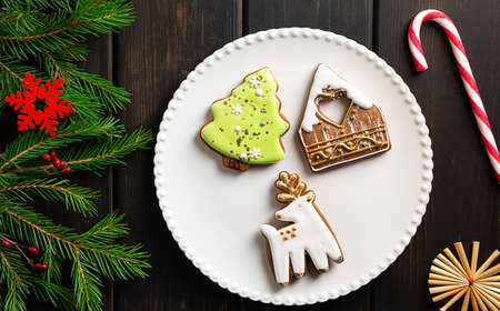 Christmas cookies on a plate on dark wooden backgroundの写真素材