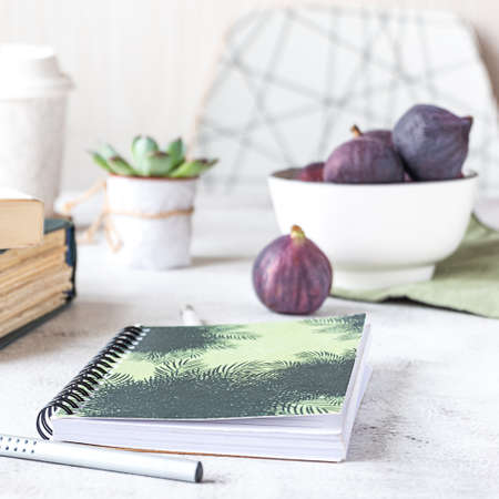 Creative workplace with a bowl of figs, side view.の写真素材