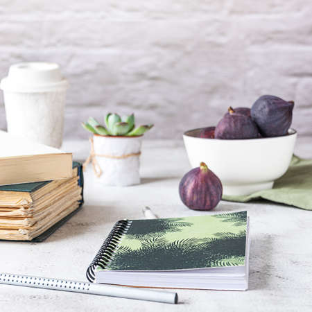 Creative workplace with a bowl of figs, side view.の写真素材