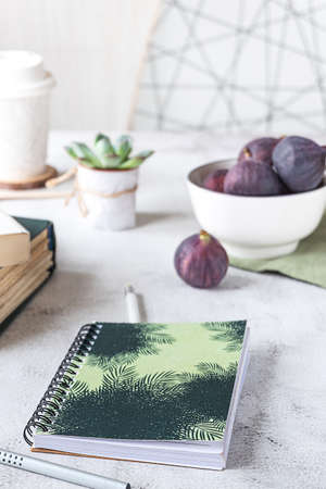 Creative workplace with a bowl of figs, side view.の写真素材