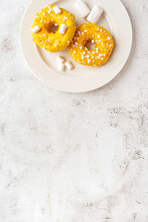 Two donuts with marshmallows served on a plateの写真素材