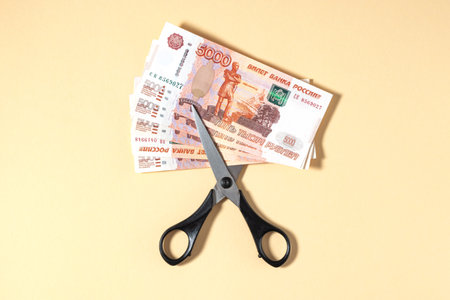 Russian rubles and scissors on a yellow backgroundの写真素材