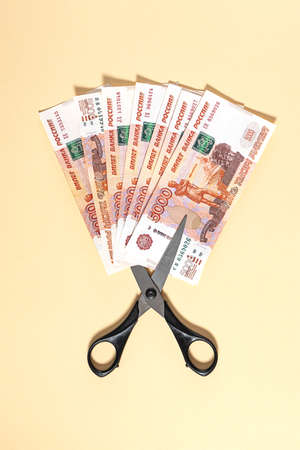 Russian rubles and scissors on a yellow backgroundの写真素材