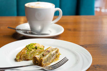Pistachio baklava dessert and a cup of coffeeの写真素材