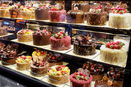 Assorted fancy cakes in a shop-windowの写真素材