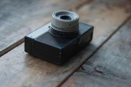 Old soviet camera on a wooden window sillの写真素材