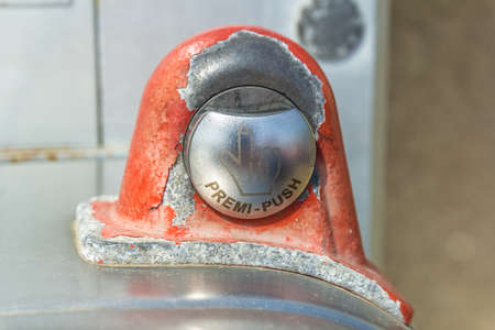 A closeup of a metal coin slot panel from a phone boothの写真素材