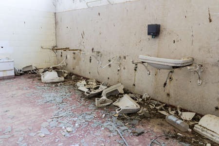 Abandoned bathroom with broken washbasinsの写真素材